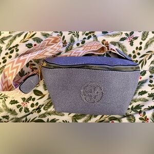 This is a denim print fanny pack with a patterned strap. (Unbranded)